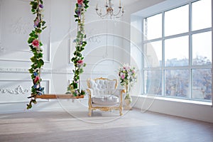 White leather vintage style chair in classical interior room with big window and spring flowers