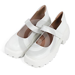 White leather women's shoes on a strap with a thick sole on a white background