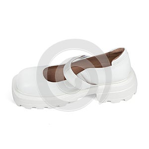 White leather women& x27;s shoes on a strap with a thick sole on a white background