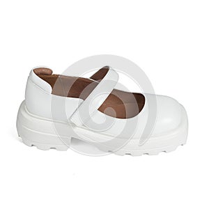 White leather women's shoes on a strap with a thick sole on a white background