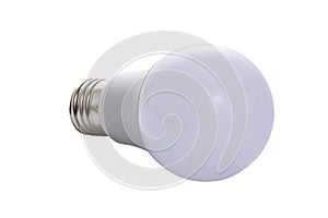 A white LED lamp with an E27 base lies on a white insulated background