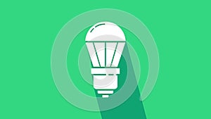 White LED light bulb icon isolated on green background. Economical LED illuminated lightbulb. Save energy lamp. 4K Video