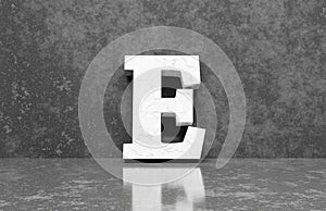 White letter E on concrete wall an floor background