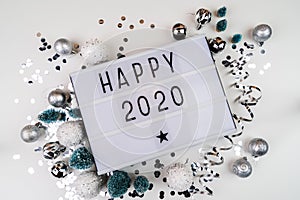 White letter lightbox with Happy 2020 surrouded with christmas decorations