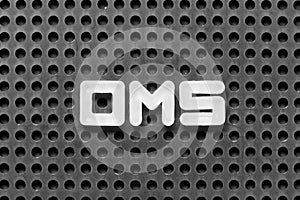 White letter in word OMS Abbreviation of Order management system or Operations management system on black pegboard