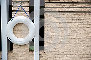 white lifebuoy,All Water rescue emergency equipment. white ifebuoy on wall near swimming pool