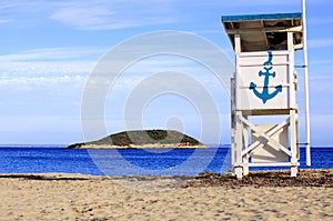 White lifeguard chair with a blue anchor on the Isla de sa Porrassa in Mallorca photo