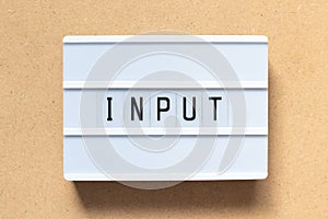 White light box with word input on wood background