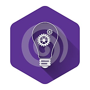 White Light bulb and gear inside icon isolated with long shadow. Innovation concept. Purple hexagon button