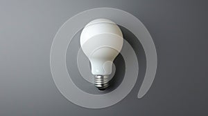 White Light Bulb Illuminating a Gray Wall