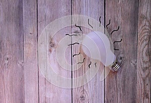 White light bulb on a wooden background