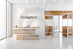 White and light oak wooden decoration elements of reception area at office, front desk