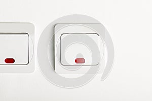 White light switch on/off on white wall with red led