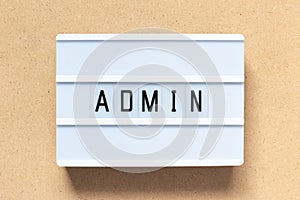 White lightbox with word admin on wood background