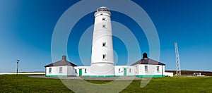 White lighthouse and associated buildings. Nash Point, Vale of Glamorgan, Wales..