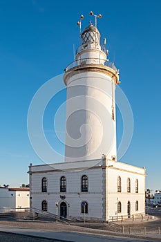 white lighthouse building (La Farola). Malaga, Costa del Sol, Andalusia, Spain photo