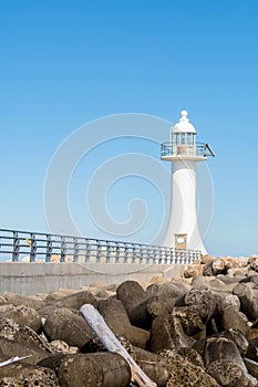 White lighthouse on concrete pier