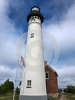 White lighthouse extending into blue sky