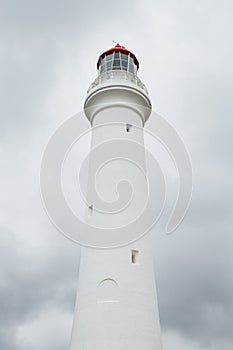 White lighthouse in front of storm clouds