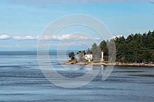 White lighthouse on the isalnd in the ocean