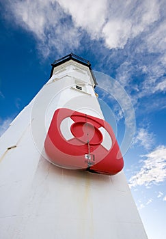 White lighthouse with lifering and blue skies
