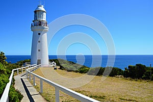 A white lighthouse on the rocky coast of the Pacific Ocean at the Cape of Good HopeSouth Australia near Melbourne