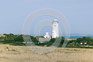 A white lighthouse on the seaside