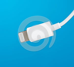 White lightning cable on a blue background