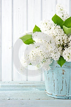 White lilac spring flowers in a blue vase