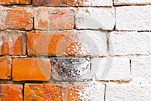 White lime splashed on a red brick wall, stain