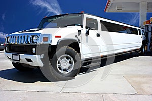 White limousine on gas station