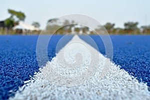 White line on blue football artificial turf texture and background