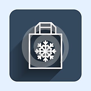 White line Christmas paper shopping bag with snowflake icon isolated with long shadow background. Package sign. Merry