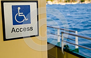 White line figure of a person seated over the axis of a wheel, blue background for wheelchair people Accessibility point.