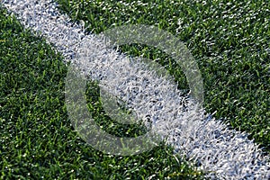 White line on the grass of sporting stadium