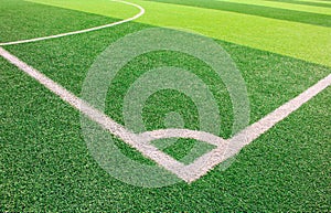 The white Line marking on the artificial green grass soccer field