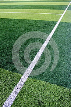 The white Line marking on the artificial green grass soccer field