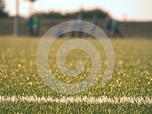 White line marks painted on artificial green turf background. Playfield border.