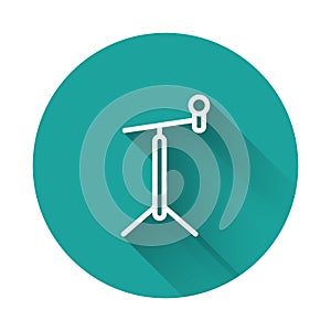 White line Microphone with stand icon isolated with long shadow. Green circle button. Vector