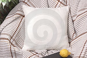 White linen pillow on a chair in cozy room, mockup