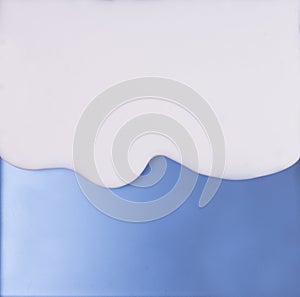 The white liquid that is flowing down on the blue material surfa