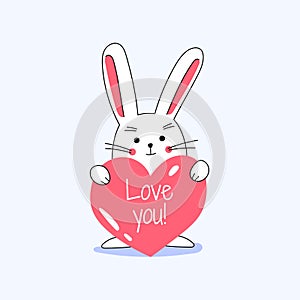 White little cute lovely rabbit holding red heart with love you typograpy and smiling, celebrating Valentine`s Day. Isolated