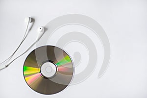 White little headphones are on CD-ROM on white background