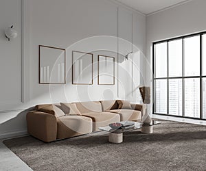 White living room corner with couch and posters