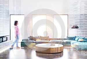 White living room interior, blue sofa, front girl