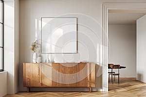 White living room interior with dresser and poster