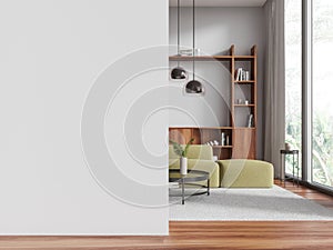 White living room interior with green couch and blank wall