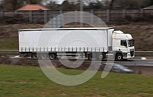 White lorry in motion on the road