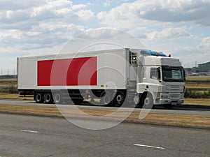 White lorry with red banner