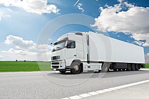 White lorry with trailer over blue sky